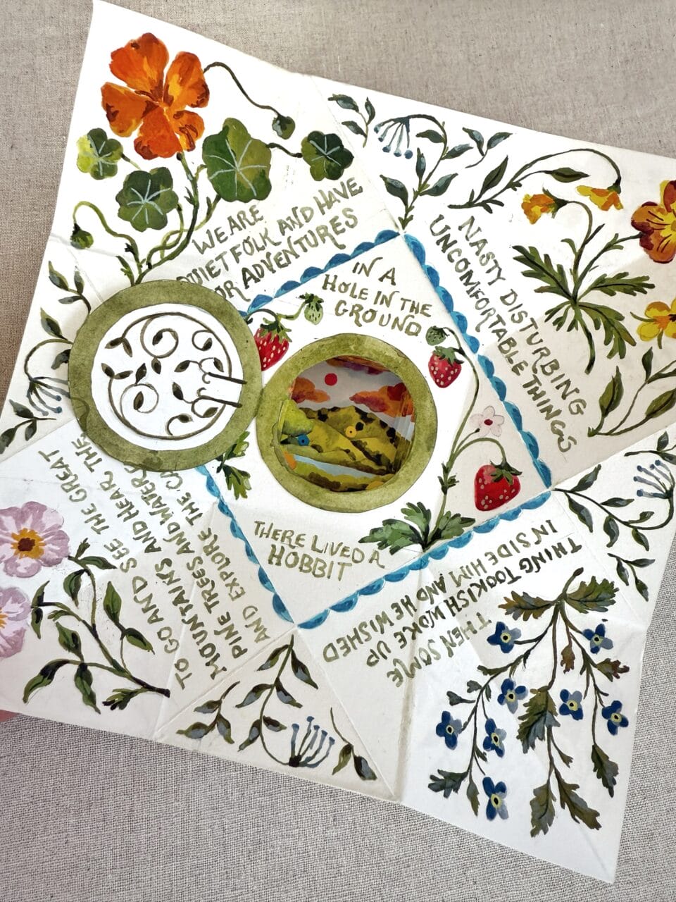 an illustrated piece of paper that functions like a narrative that can be folded and unfolded to reveal the message