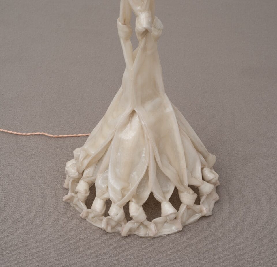 the base of a sculptural lamp made from twisted pieces of fabric coated in bio resin and knotted