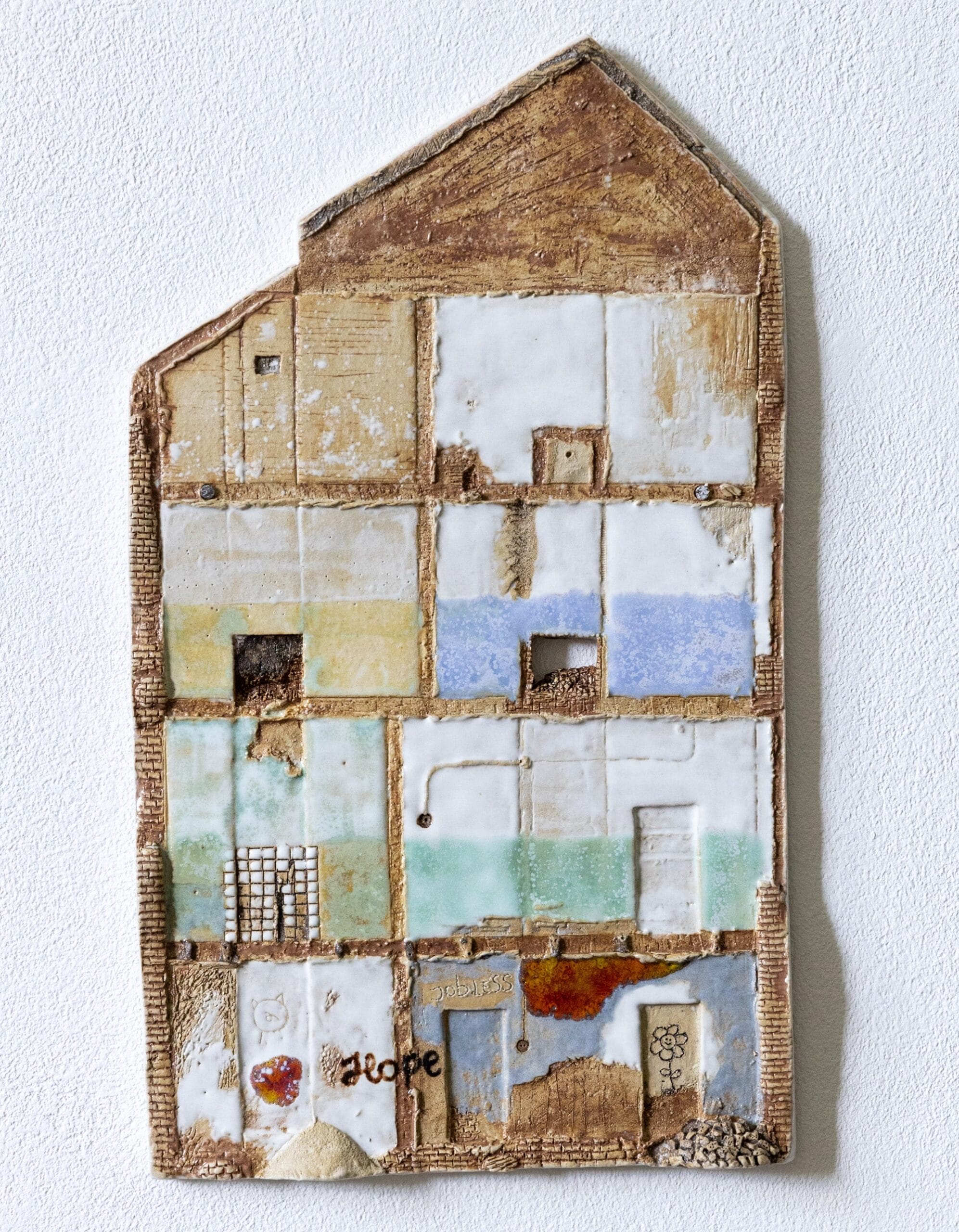 a sculptural relief artwork resembling the textures and colors of a building's end wall where another structure was removed, leaving outlines of the floors and paint on the walls